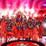 Dynamic digital illustration for CricIndeed IPL 2026 review, featuring a stylized young Indian cricketer lifting a T20 championship trophy against a packed, vibrant stadium background.